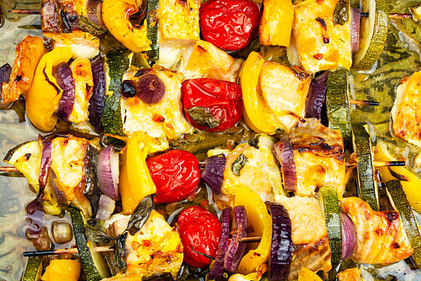 istock Skewers with fish and vegetables on baking sheet. 2228887369
