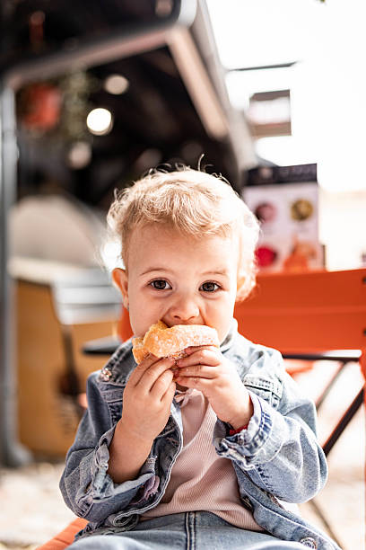 istock Little Girl Eating Doughnut 2228889864