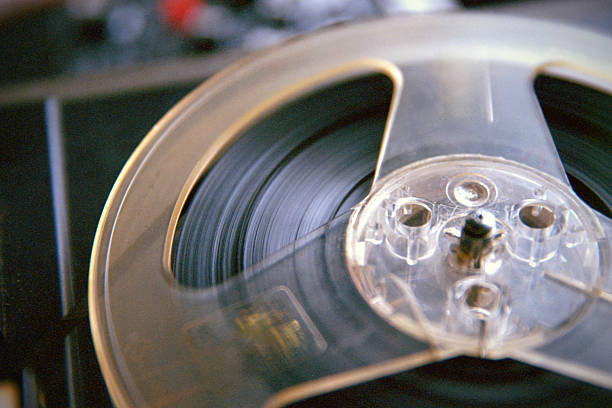 Analog photograph showing close detail of spinning tape reel mechanism with motion blur and film grain texture