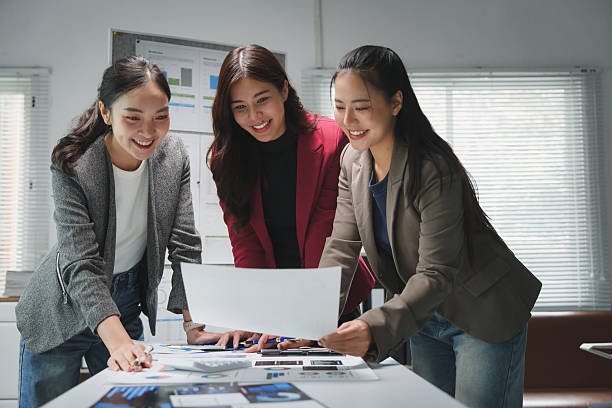 istock Young businesswomen collaborating on charts and documents in office 2228891711