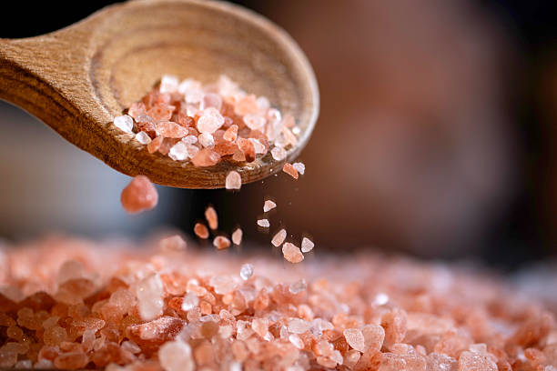 Himalayan salt - pouring from a wooden spoon