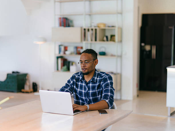 istock African American Man Calling While Working on Laptop 2228892556