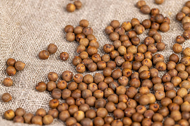 chickpeas are scattered on the table before cooking, fried chickpeas are on the table with a linen tablecloth, closeup