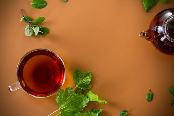 istock Green tea with currant leaves and mint in glass teapot and cup 2228893018