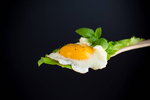 istock Homemade breakfast with fried egg and fresh lettuce leaves 2228893256