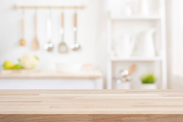 istock Wood table surface with copy space for your product montage on blurred kitchen interior background 2228894999