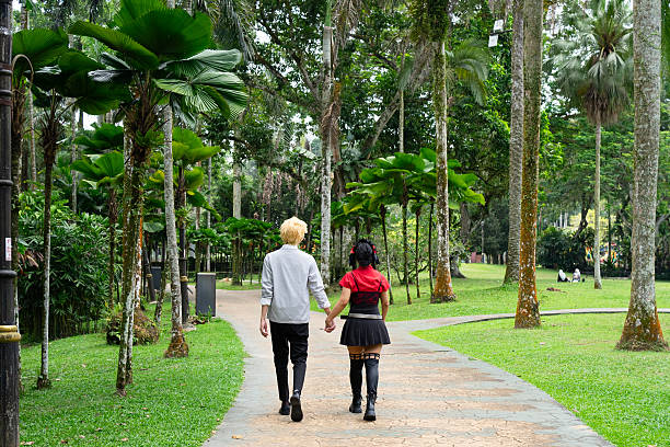 istock Cosplayers walking hand in hand in a lush park 2228895917