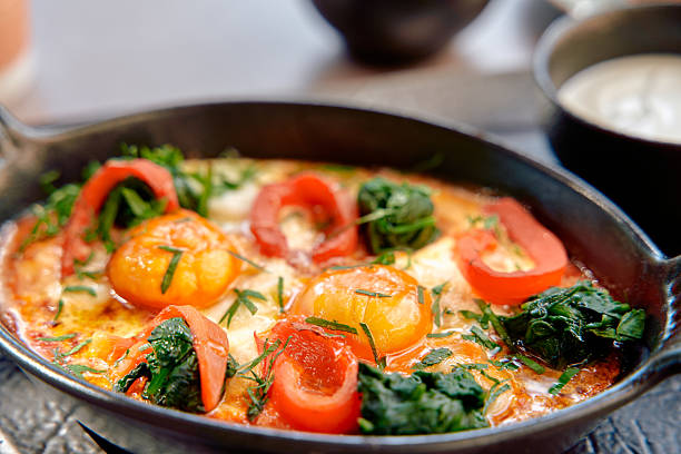 istock A Deliciously Crafted Dish Featuring Sizzling Eggs Surrounded by Fresh Vegetables and Vibrant Spices, Perfectly Cooked in a Skillet for Maximum Flavor 2228898418