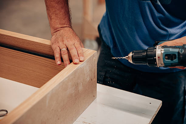 istock Man Drilling Screws into MDF Cabinet for Assembly 2228899867