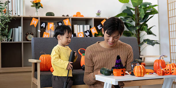 istock Halloween Crafting. Parent and child creating festive decorations together. 2228904154