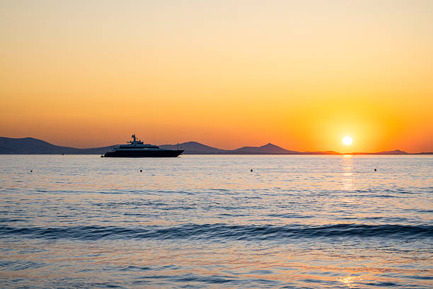 As the sun sets over the Aegean, a yacht drifts peacefully. A quiet symbol of freedom, prosperity, and timeless seafaring luxury.