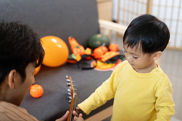 istock Creative Play. Father and son engaging with Halloween decorations and guitar. 2228904631