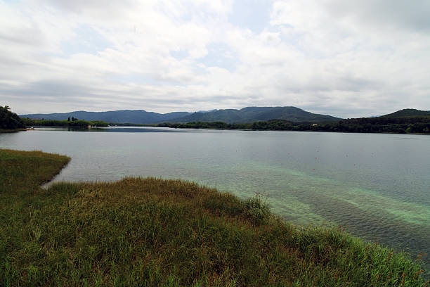 istock Landscape with Lake, Sky, and Rolling Hills Around 2228905961