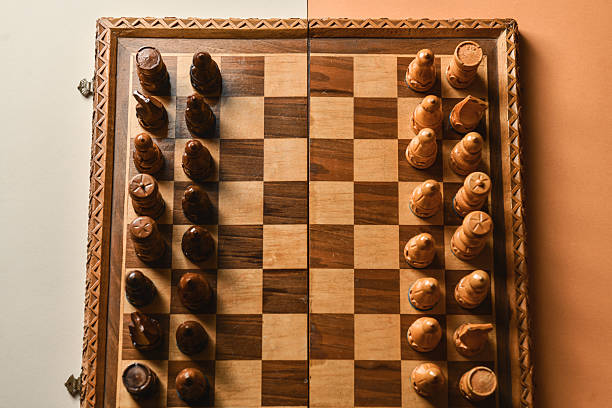 Strategically Placed Rival Chess Pieces On Traditional Wooden Chess Board