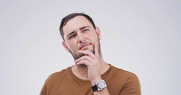 istock Planning, thinking and question with man on studio space for brainstorming, contemplation or solution. Ideas, problem solving and why with person isolated on white background for choice or decision 2228911411