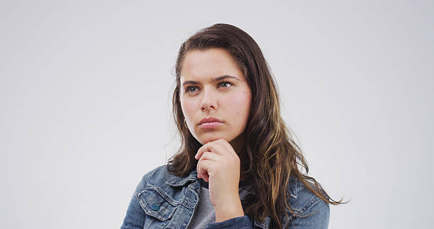 istock Face, ideas and thinking with woman on studio space for brainstorming, planning or problem solving. Solution, question and vision with person isolated on white background for thoughtful contemplation 2228911424