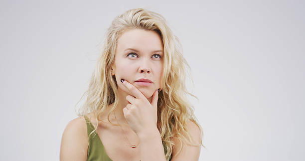 istock Ideas, thinking and why with woman on studio space for brainstorming, contemplation or wonder. Choice, decision and planning with face of person isolated on white background for thought or vision 2228911472