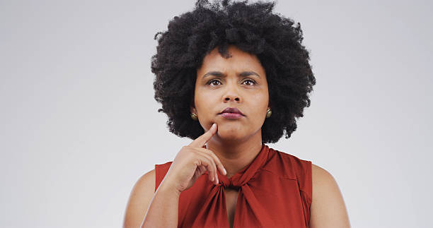 istock African woman, thinking and studio with reflection, mock up space and confused on white background. Person, perspective and doubt for decision, solution or choice with insight for problem solving 2228911517