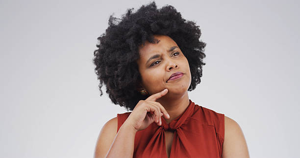 istock African woman, thinking and studio with doubt, mock up space and confused on white background. Person, perspective and reflection for decision, solution and choice with insight for problem solving 2228911518