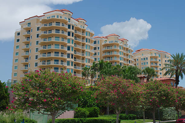 istock Modern Apartment Buildings Surrounded by Greenery on Sunny Day 2228919271