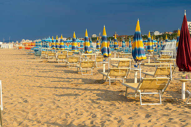 istock Beach with Umbrellas and Deck Chairs on Sand 2228920226