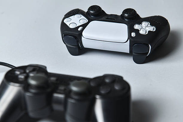 istock Old School Wired Joystick Meets New School Wireless Controller On Gray Background 2228920512