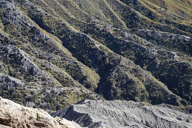 istock Barren mountainous landscape, cascading slopes with sparse vegetation in a natural setting, showcasing geological formations with a muted color palette and rugged texture mountain scenery 2228921269