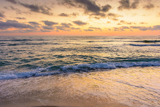 istock sea wave touch the sand beach at dawn 2228921531