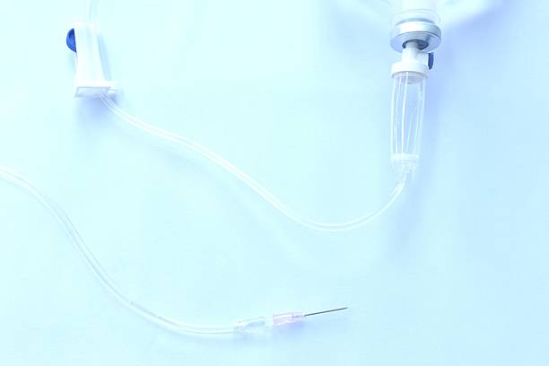istock needle for saline solution and rubber tube arranging on white background 2228924353