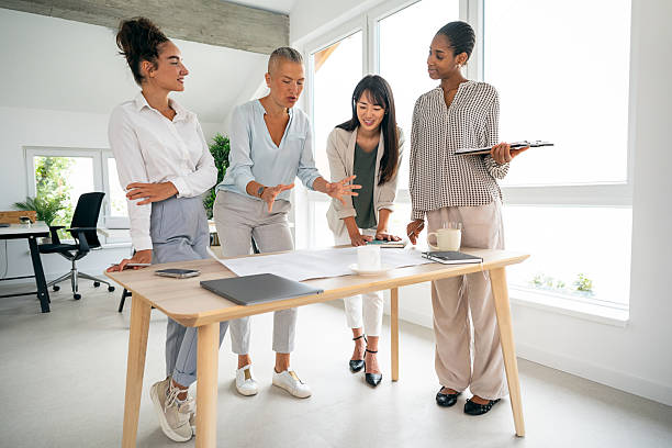 istock Diverse female business team collaborating at a modern office for a creative project 2228930473