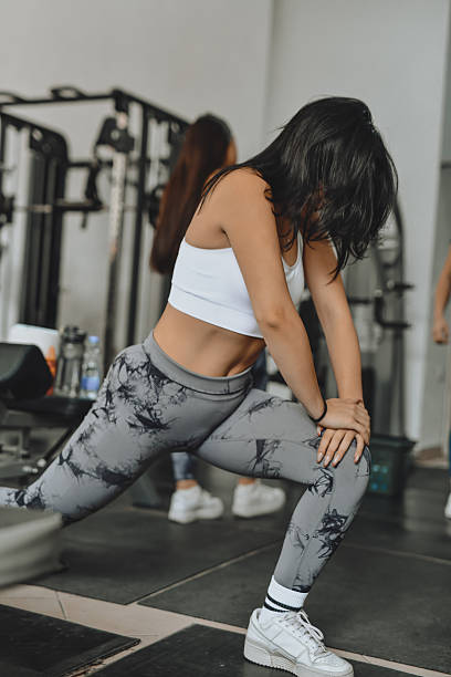 istock Woman Performing Forward Lunges To Warm Up Legs Before Workout 2228930667