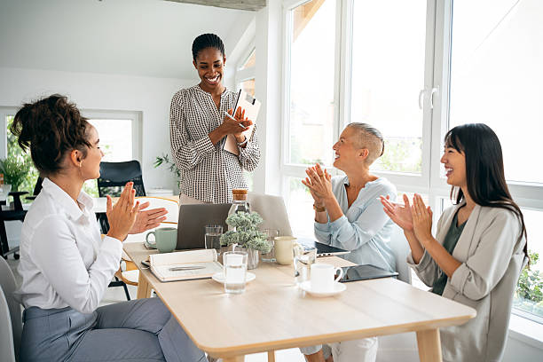 istock Team applauding young Black presenter after winning pitch 2228931435