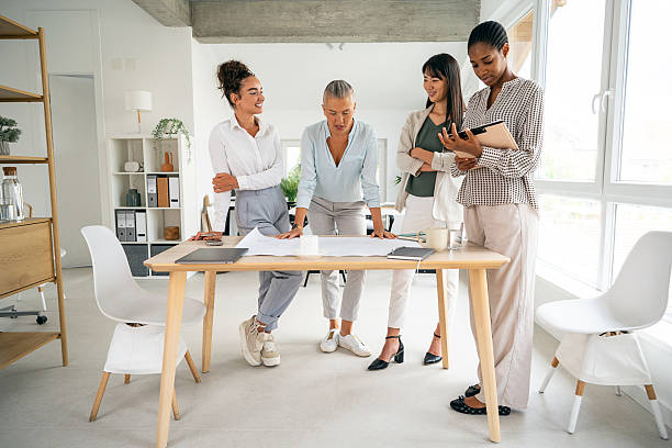 istock Diverse women collaborating during an office meeting around a desk 2228931475