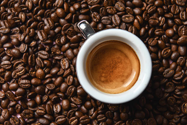 istock Fresh Brewed Coffee In Cup Framed By Coffee Beans Overhead View 2228932622