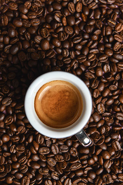 Aromatic Coffee Surrounded By Rich Brown Roasted Beans Shot From Above