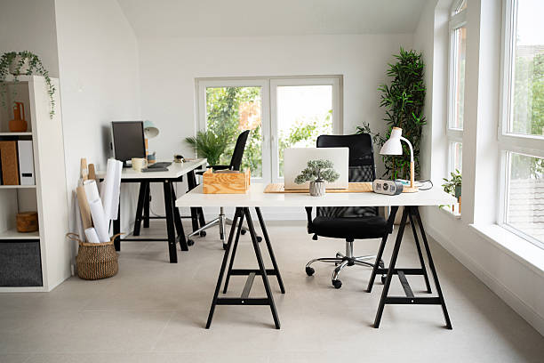 istock Modern office space with natural light and organized workstations 2228932714