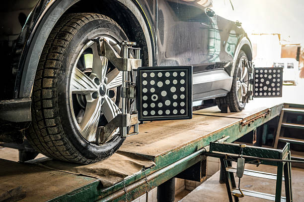 istock Car wheel alignment. Auto camber toe check fixing. Sensor during suspension adjustment and automobile wheel alignment work at the repair service station 2228932966
