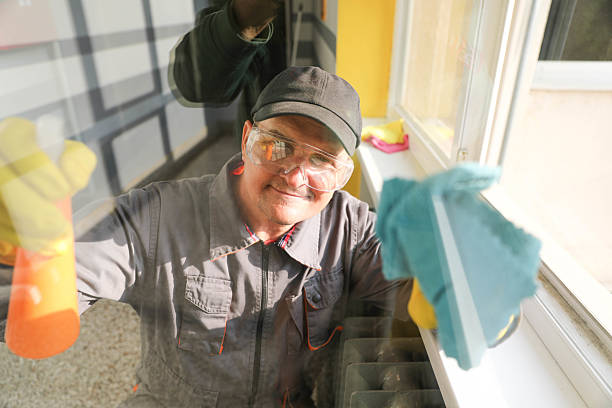 istock Window Cleaning by Senior Male with Rubber Gloves 2228933097