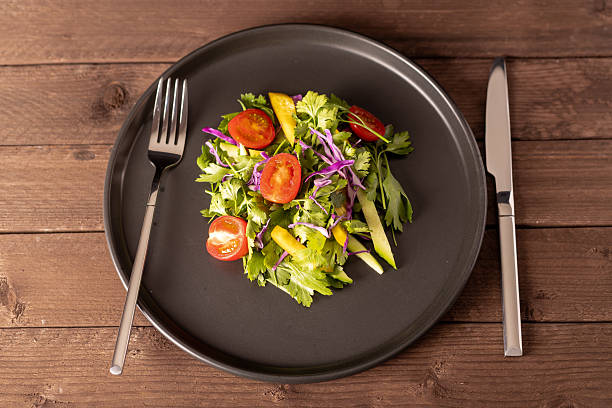 istock A vibrant, fresh salad is presented on a minimalist dark gray plate, centrally 2228933124