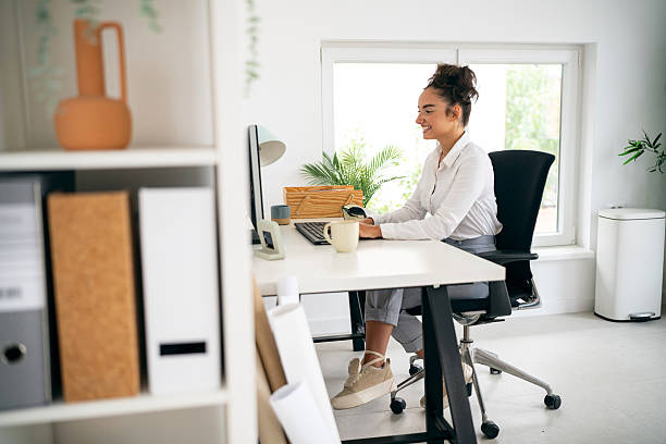 istock Woman working at her desk in a bright office environment 2228933174