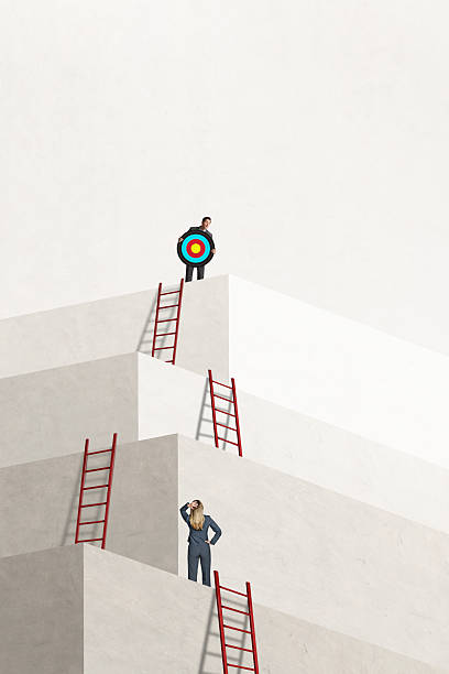 istock Man Holding Target Looks Down At Woman 2228934460