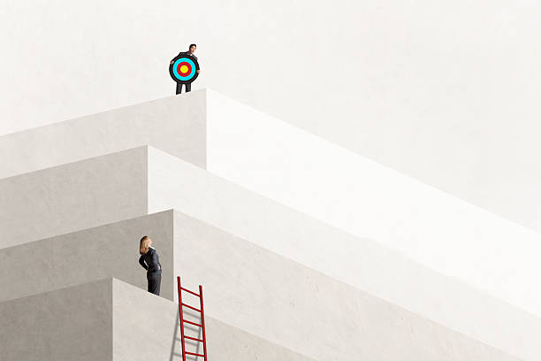 istock Man Holding Target Looks Down At Woman 2228934462