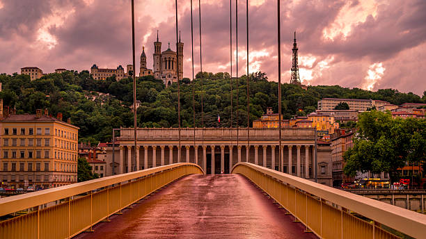 Lyon, France - june 30, 2025 : Pierre Truche footbridge over the Saône River and the Lyon Court of Appeal at dusk after the storm