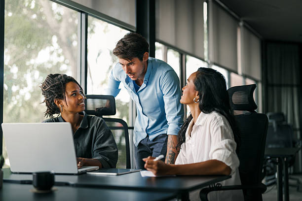 istock Group of young multi-ethnic startup business team collaborating on project in modern office 2228935001