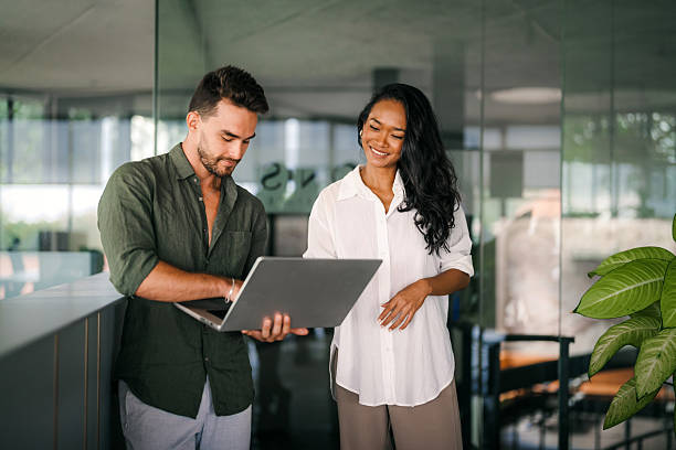 istock Two happy diverse multiethnic business team people working, talking in corporate office 2228935232
