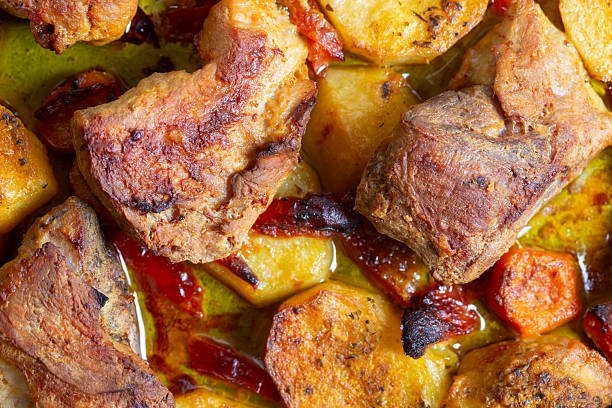 roasted pork with potatoes and carrots in tray
