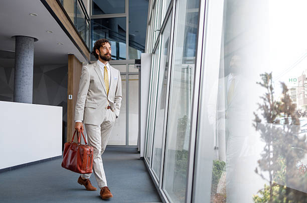 istock Young businessman walking through a modern office building 2228940186
