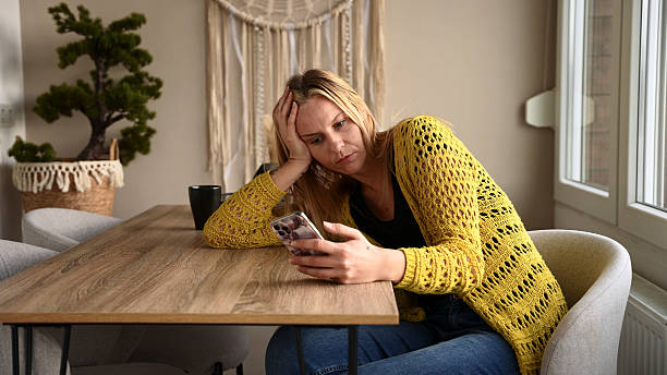 istock Woman Feeling Worried While Using Smartphone at Home 2228941996