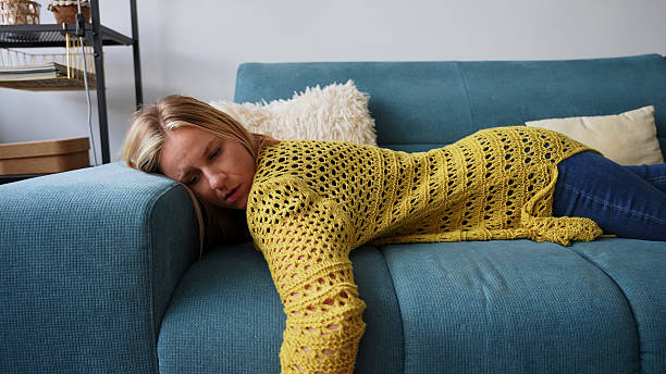 istock Exhausted Young Woman Sleeping on the Sofa After a Long Day 2228942513