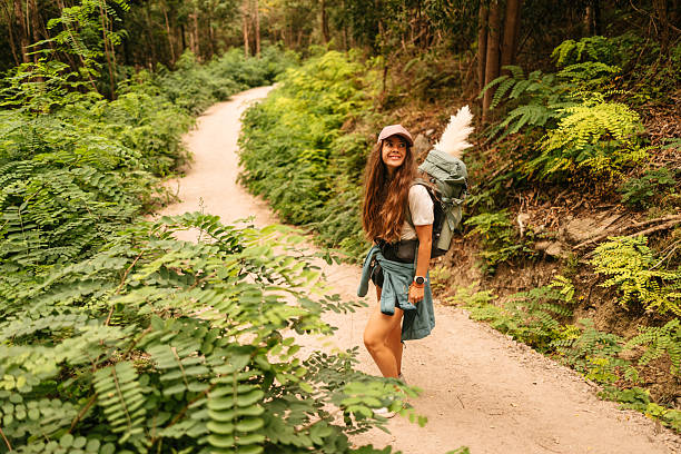 istock Woman hiker smiling on forest trail with backpack 2228944512